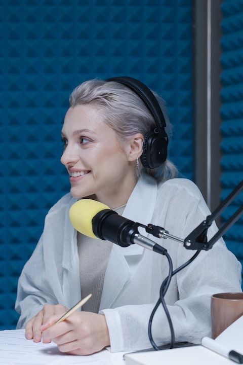 woman-in-white-long-sleeve-shirt-wearing-black-headphones