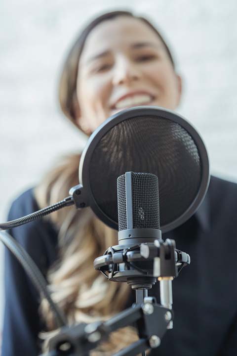 woman-smiling-and-recording-audio-message