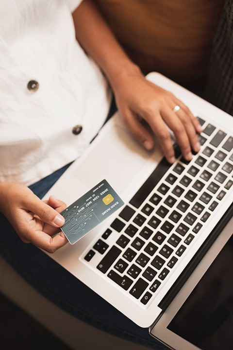 top-view-hands-holding-credit-card-laptop
