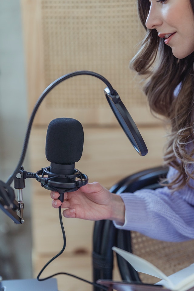 woman-recording-podcast-on-microphone