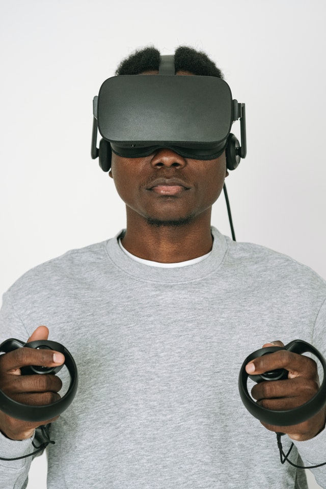a-man-in-gray-sweater-enjoying-the-vr-headset-he-is-playing